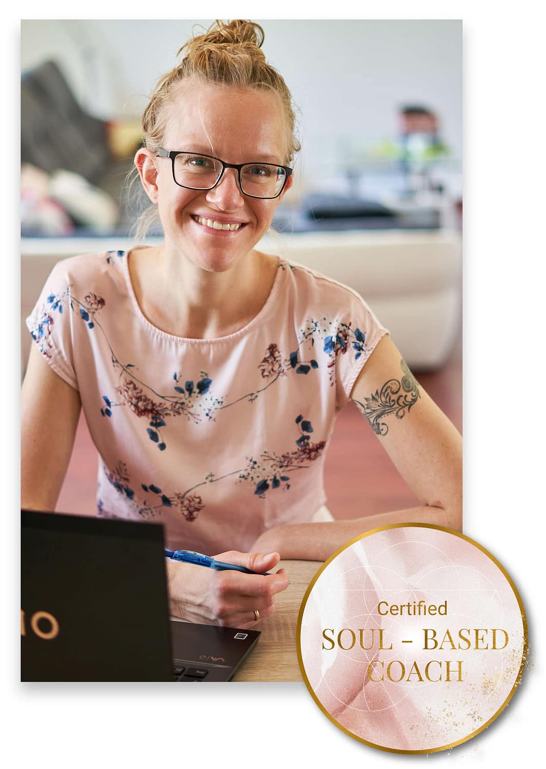 Lisa at her desk with Soul-based Coaching Badge