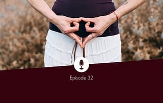 Picture of two hands held in a yoni mudra in front of the womb space of a person