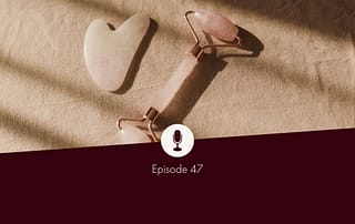 Photo of Gua Sha roller and Gua Sha stone (Chinese facial massage accessories) made of rose quartz on a beige linen cloth