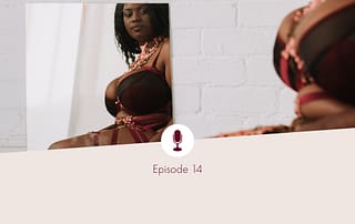 Black voluptuous person in lingerie, looking at themselves lovingly in a mirror